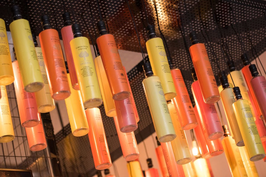 multicolored cylinder bottles hanging from the ceiling at Lazaris Distillery store